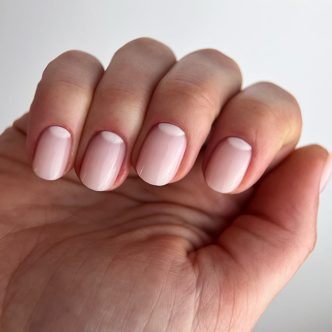 Close-up of nails created with Paloma Builder Gel (hard gel) in shade G015 Old Money, showcasing a semi-transparent nude finish. This elegant, minimalist manicure features a smooth, glossy look, perfect for a natural yet polished appearance. The durable, long-lasting formula ensures a flawless finish.