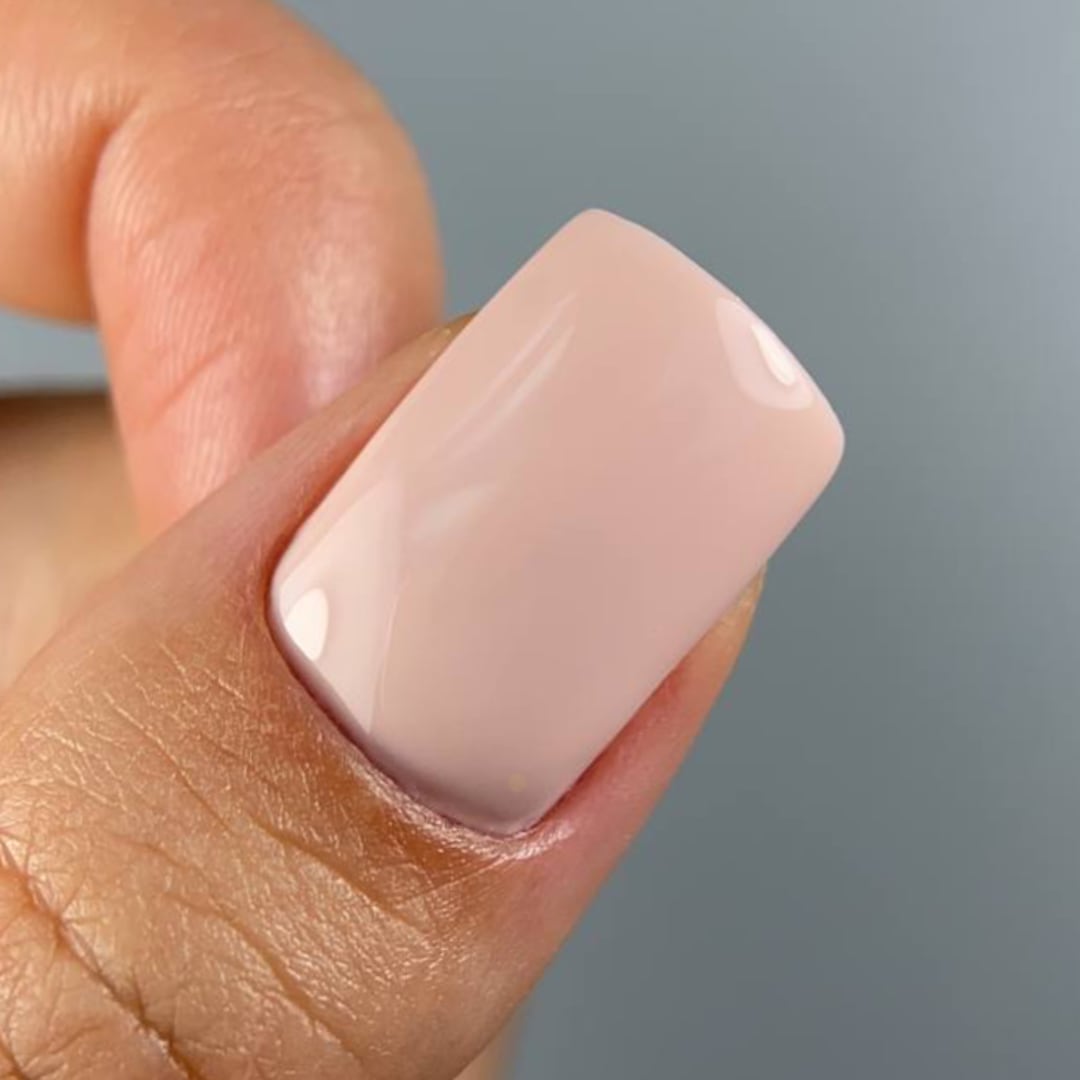 Close-up of a nail painted with Paloma gel polish in shade C072 from the Nude Collection, a warm pinkish nude perfect for creating a soft nude manicure or a classic French base. This highly-pigmented, long-lasting gel polish provides a beautiful, glossy look.