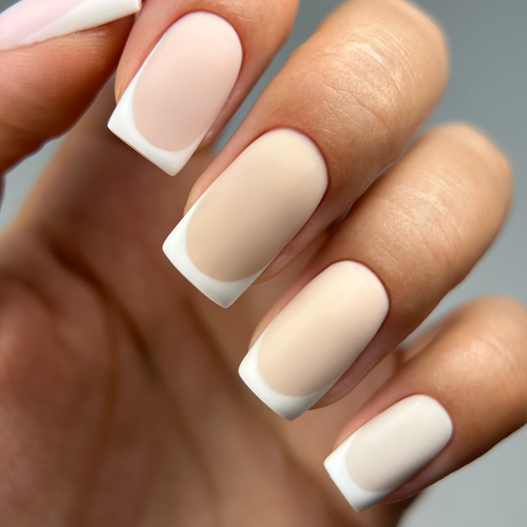 Close-up of a matte French manicure using shades from Paloma's Nude Collection, featuring soft nude tones as the base with crisp white French tips. This elegant and timeless design highlights the versatility of highly-pigmented, long-lasting nude gel polishes, perfect for a classic French manicure.